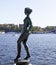 statue depicting naked woman from the side by the water