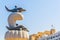 Statue of a dolphin on a Muttrah corniche with a fortress on background, Muscat, Oman