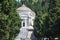 Statue of Faith or Religion and Pantheon in monumental cemetery of Genoa, Italy.