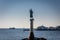 Statue of fishermanÂ´s woman Fiskerkona in the port of Svolvaer on the Lofoten islands on clear winter day with snow waiting for