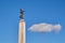 Statue of freedom angel pointing at cloud on blue sky