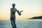 Statue of a Girl Holding a Seagull at Sunset in Opatija, Croatia