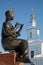 Statue of girl playing flute with church in background, Vologda, Russia