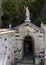 Statue and graves in a small cemetary behind the Church of San Giorgio atop a hill in Portofino, Italy.