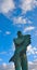 Statue in gray stone of a proud sailor