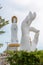 Statue of Guanyin on the territory of Buddhist center Nanshan on a cloudy day