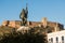 The statue of Hernan Cortes with castle of Medellin in the background, Extremadura, Spain.