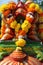 Statue in Hindu temple with festive decoration of orange and yellow Marigold Tagetes flowers