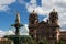 Statue of the Inca Emperor with the Church of the Compania de Jesus on the back in Cuzco