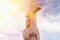 The statue of Jesus Christ with a cross. The rays of the sun religion, Christianity