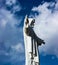 Statue of Jesus (Cristo Blanco) monument overlooking the city of Cuzco Peru, against a bright blue cloudy sky