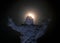 Statue of Jesus with a full moon passing over