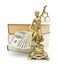 Statue of justice, money and books on a white