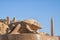 Statue of Khepri the sacred scarab in Karnak Temple (Luxor, Egypt) with obelisk