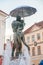 Statue of kissing students under umbrella n