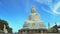 A statue of a large white Buddha. religious asian shrine. temple on the mountain. Buddhism, travel and tourism.