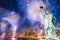 The Statue of Liberty with blurred background of cityscape with beautiful fireworks at night, Manhattan, New York City