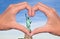 Statue of liberty and hands forming a heart, New York love and travel concept