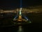 a statue of liberty lit up at night next to the water