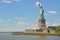 Statue of Liberty looking beyond the wide blue sky background