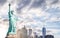 The Statue of Liberty with Lower Manhattan background in the evening at sunset