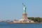 Statue of Liberty and panoramic view of Manhattan City skyline.