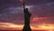 The Statue of Liberty, Sunrise Time Lapse. Sunbeam lights the torch of the statue of liberty. Animation.