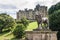 Statue of lion with Alnwick Castle and grounds