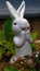 A statue of a little funny rabbit looking suprised at something