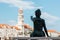 Statue of a little girl pointing at the belltower in the coastal small town of Sutivan on the island of Brac, Croatia