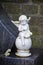 Statue of a little praying angel as decoration on a grave