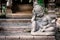 Statue of little, thinking demon in front of temple in Chiang Ma