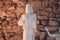 Statue of lord Jesus standing with a background of rocks fixed in the wall