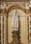 Statue of the Madonna with prayerful hands and a crown inside the Sanctuary of Our Lady of Nazare in Portugal.