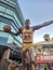 A statue of Magic Johnson dribbling a basketball a Lakers uniform with the number 32 in front of Crypto.com Arena in Los Angeles