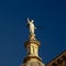 Statue of a man holding a sword and a feather, detail of Granada cathedral