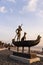 Statue of a man riding a boat with a dog and seagull at Bostanli Izmir