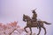 A statue of Masamune Date on horseback entering Sendai Castle in full bloom cherry blossom, Aobayama Park, Sendai, Miyagi, Japan