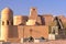 Statue of Mathematician Al Khoresmy with the city walls of Khiva in the background, Khiva