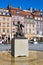 Statue of Mermaid Syrenka - symbol of Warsaw at Old Town Market Square against tenements and re