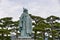 Statue of Mikimoto Kokichi with pine trees