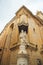 Statue of a mother and a child in front of an old building of Mdina Gate in Malta