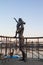 Statue of mother and son greeting the sailor on the pier