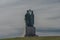 Statue near brown wooden old chapel on Radhost hill in Beskydy mountains