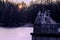 Statue next to a frozen lake at a park in Warsaw at sunset