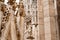 Statue of a noble commander in beautiful clothes on the facade of the Duomo. Italy, Milan