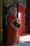 Statue of a novice monk at the entrance of the Ordination Hall in Wat Ming Muang, Nan, Thailand