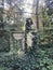 Statue in overgrown cemetery in Germany, grave