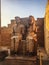 The statue of Pharaoh and his wife seated on a throne in the Luxor temple at sunset. Egypt, Luxor.