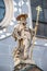 Statue of pilgrim priest with a cross, lion and book at the main facade of St. Peter`s Catholic Church in Vienna downtown, Austri